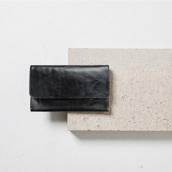 STATUS ANXIETY Black Audrey Wallet styled with cement block