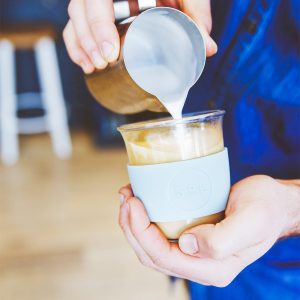 cool cyan SoL Cup being filled with coffee by barista