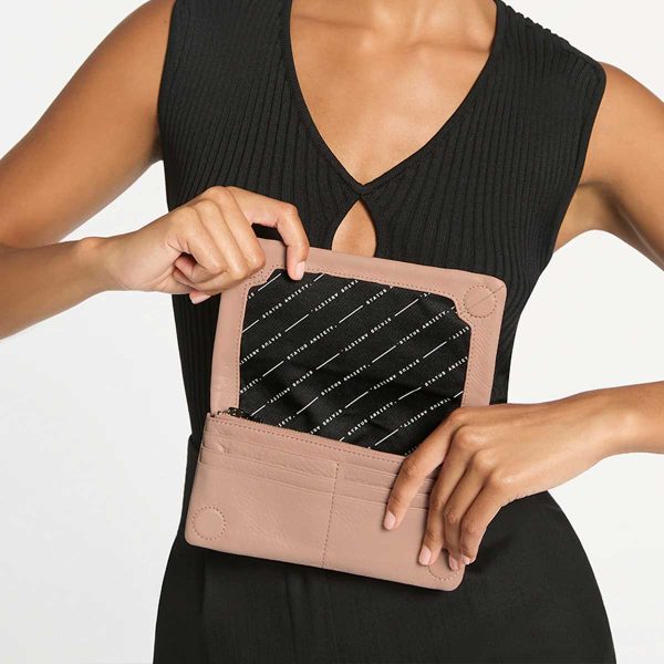woman in black dress showing the inside of the Some Type of Love Dusty Pink Wallet
