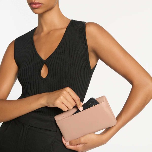woman showing the phone compartment of the Some Type of Love Dusty Pink Wallet