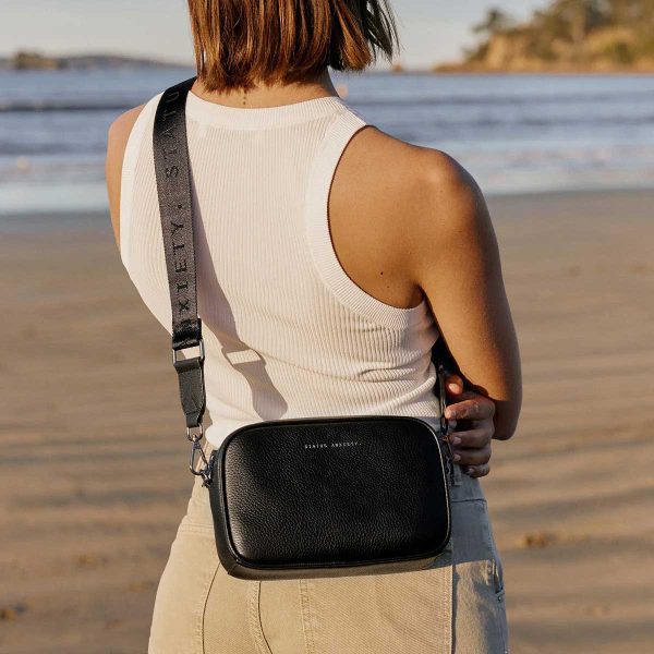 at the beach with the status anxiety black plunder bag with thick strap